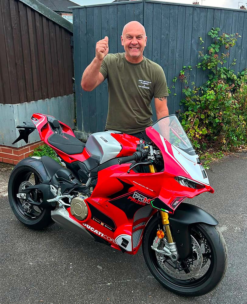 Raffle winner with his £40,000 Ducati Panigale V4 R following delivery in Hull, East Yorkshire