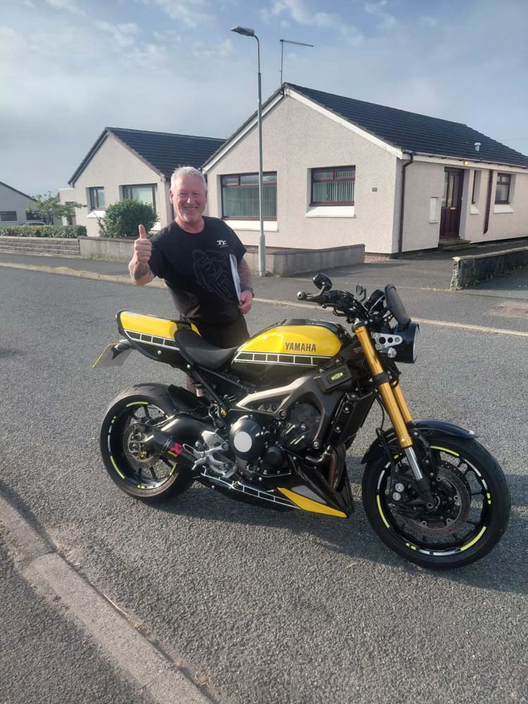 Customer with his Yamaha after motorcycle collection and delivery